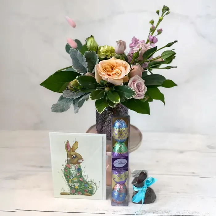 easter flowers and choclate bunny and chocolate eggs